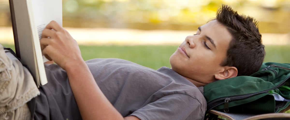 A teen boy reading