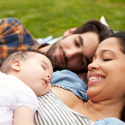 Parents hold their newborn infant