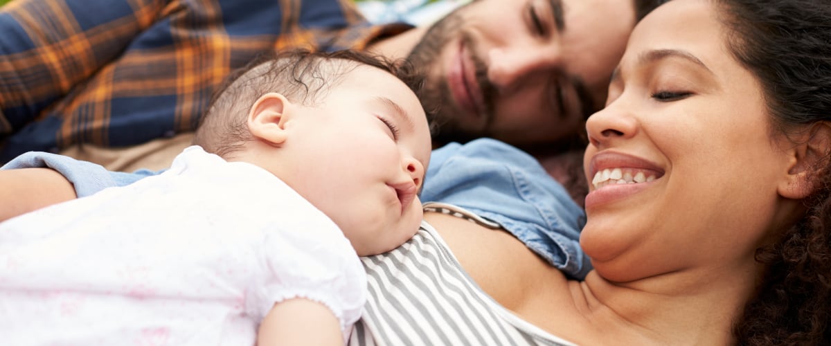 Parents hold their newborn infant